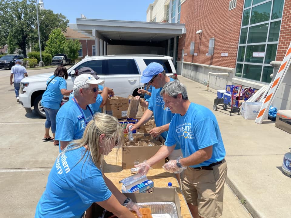 John and other Community Core volunteers serving food at a Little Rock community celebration